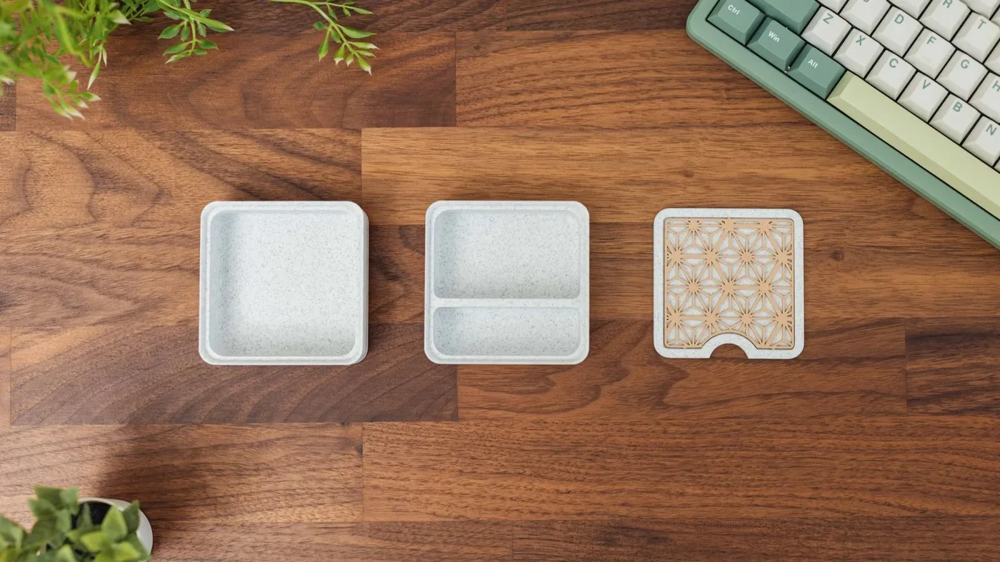 3D printed pieces arranged on a wooden desk.