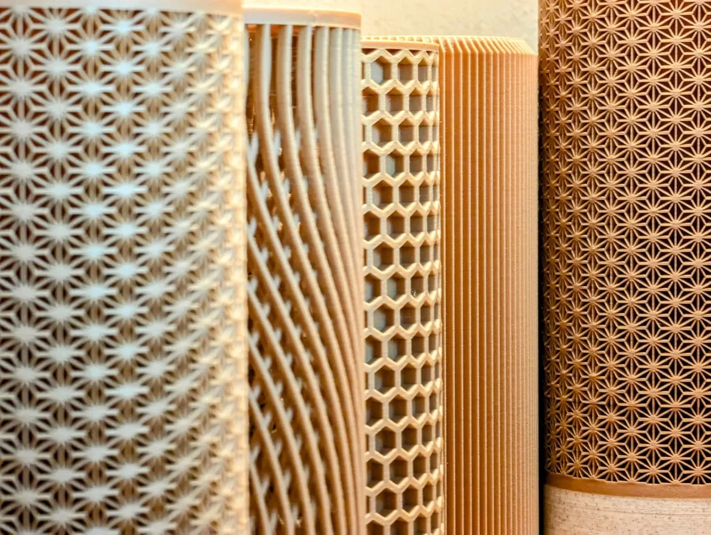 Close-up view of several cylindrical bamboo or wooden objects with intricate geometric patterns.