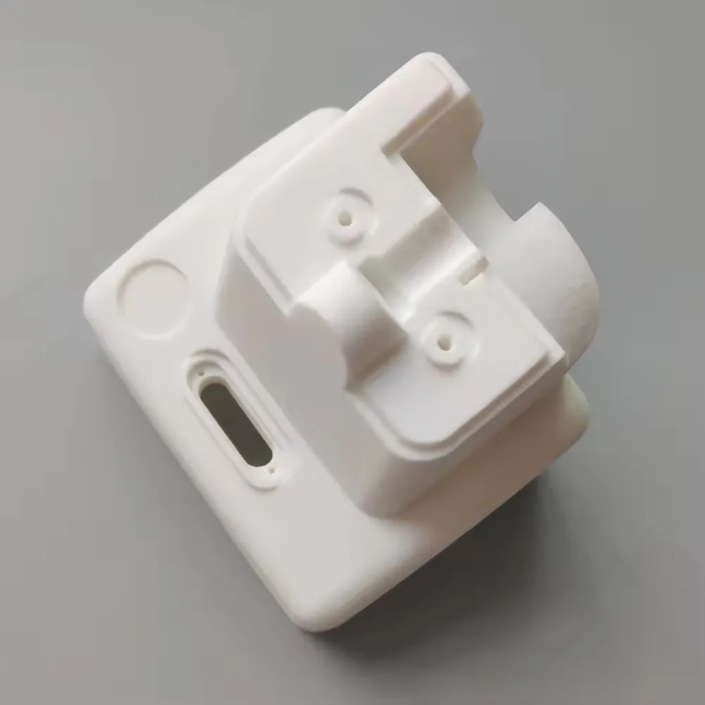 A white SLA resin enclosure with moulded bosses and a slot, printed in one piece.