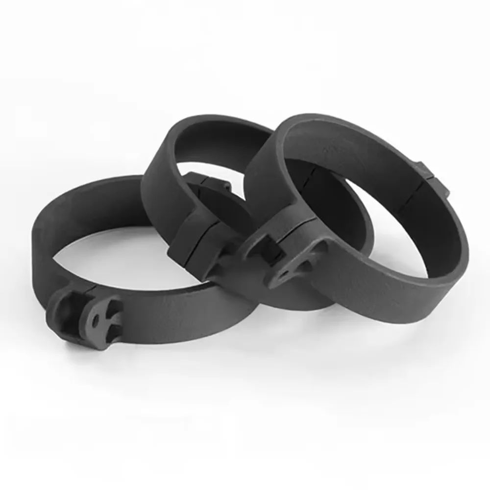 Three black SLS nylon band clamps with hinged buckles, stacked together.